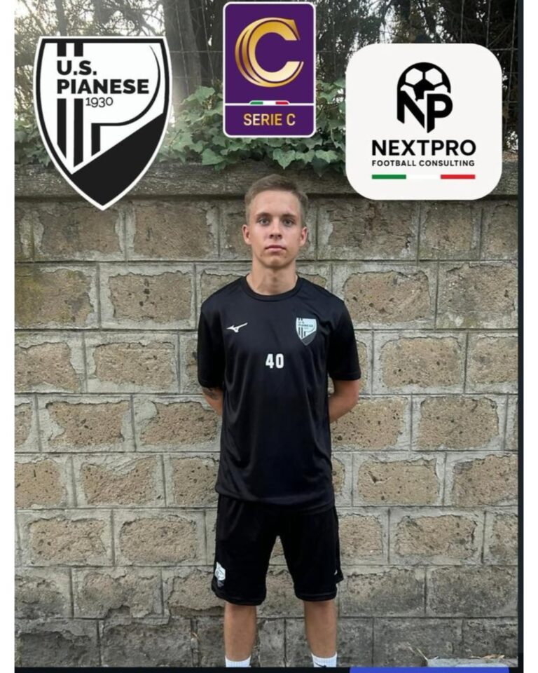 A football player is standing by the wall